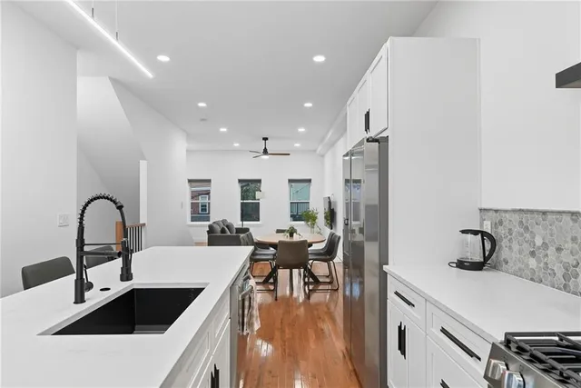 a kitchen with a refrigerator and a sink