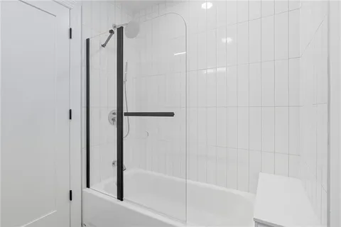 a bathroom with a shower and a glass door