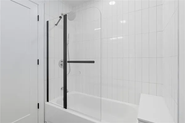 a bathroom with a shower and a glass door