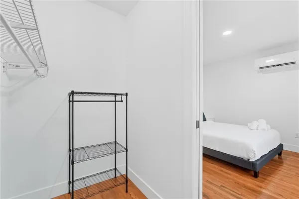 a bedroom with a bed and a mirror