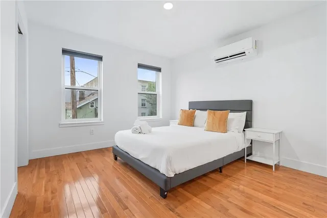 a bedroom with a bed and window