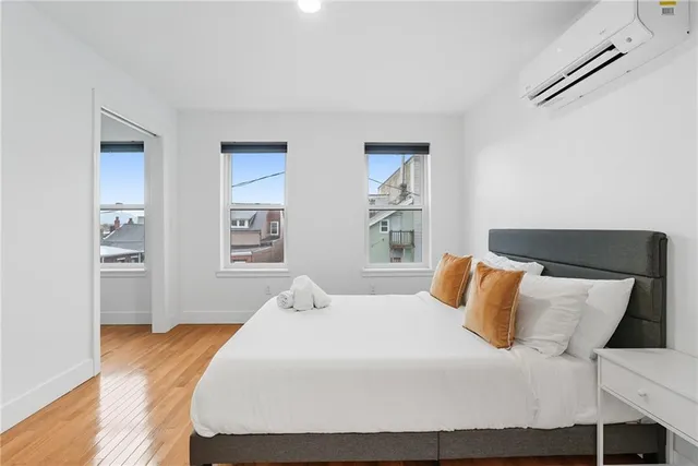 a bedroom with a bed and a window