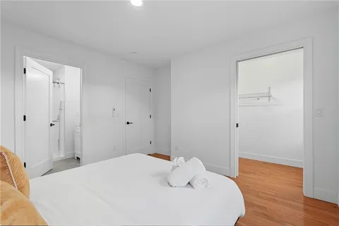 a bedroom with a bed and wooden floor