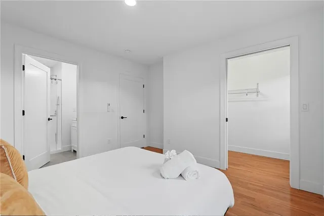 a bedroom with a bed and wooden floor