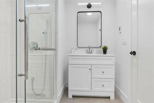 a bathroom with a double vanity sink mirror and