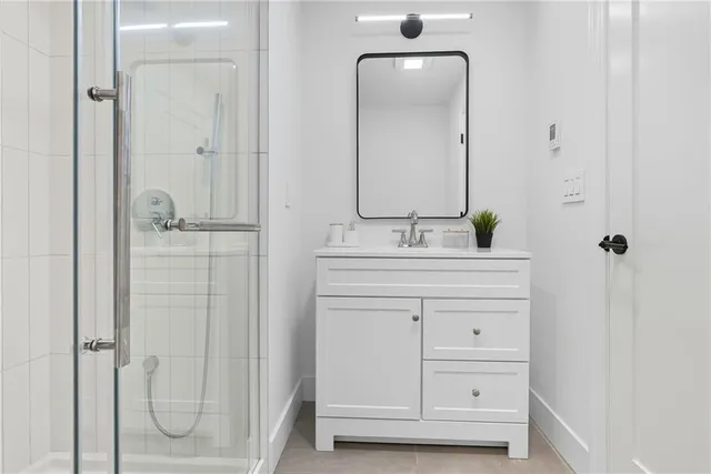 a bathroom with a double vanity sink mirror and