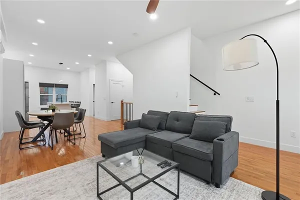 a living room with furniture and kitchen view