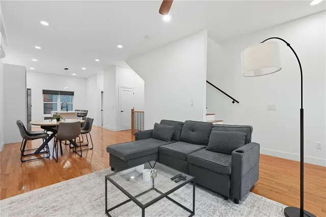 a living room with furniture and kitchen view