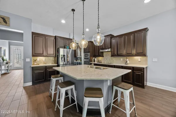 a kitchen with lots of counter space a sink and appliances