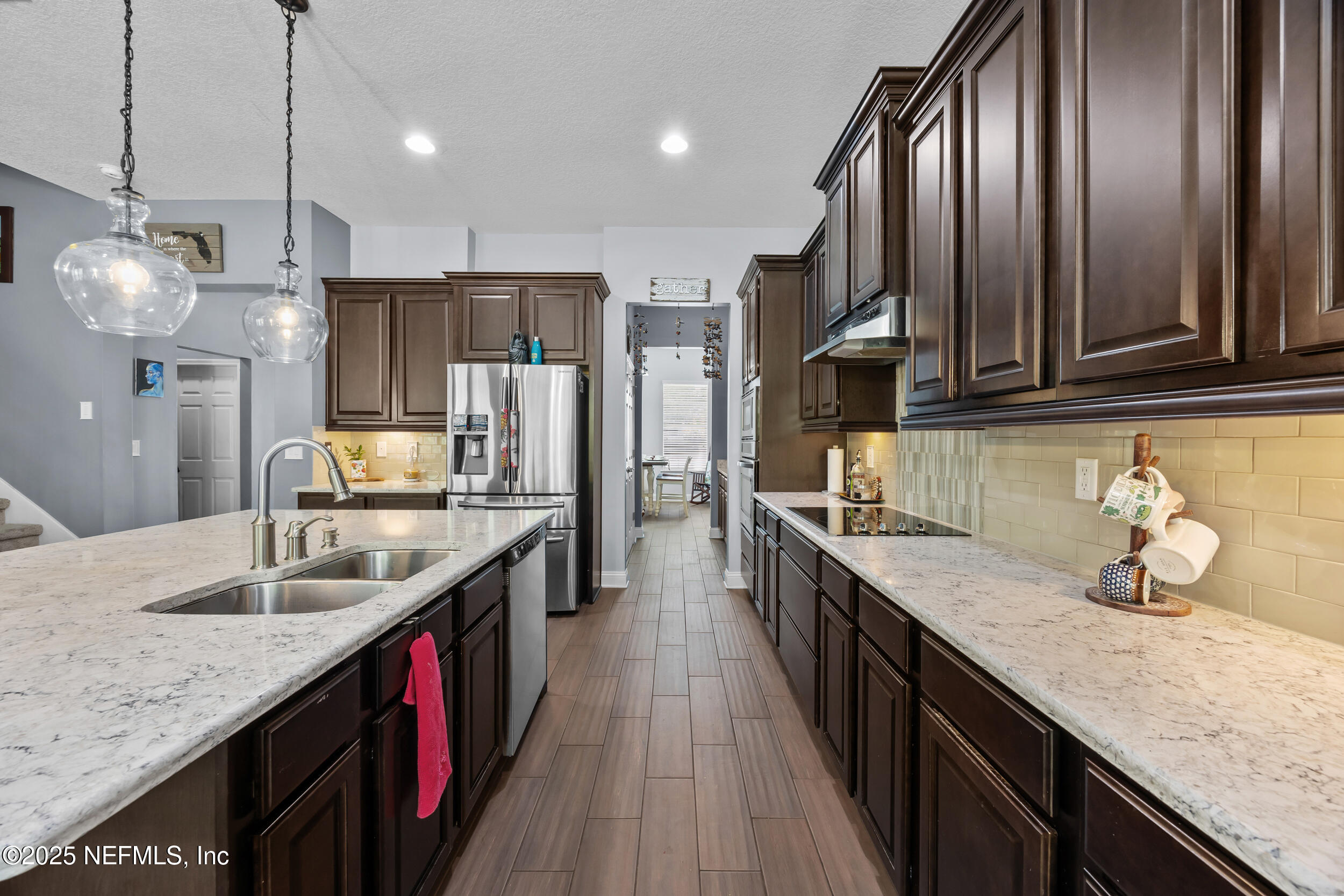45 Oban Court St. Johns, FL 32259 - Photo 18 of 53 a kitchen with stainless steel appliances granite countertop counter space cabinets a sink and a center island