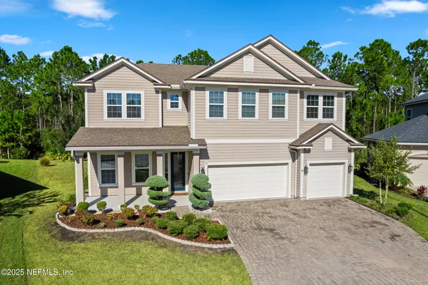 a front view of a house with a yard and garage