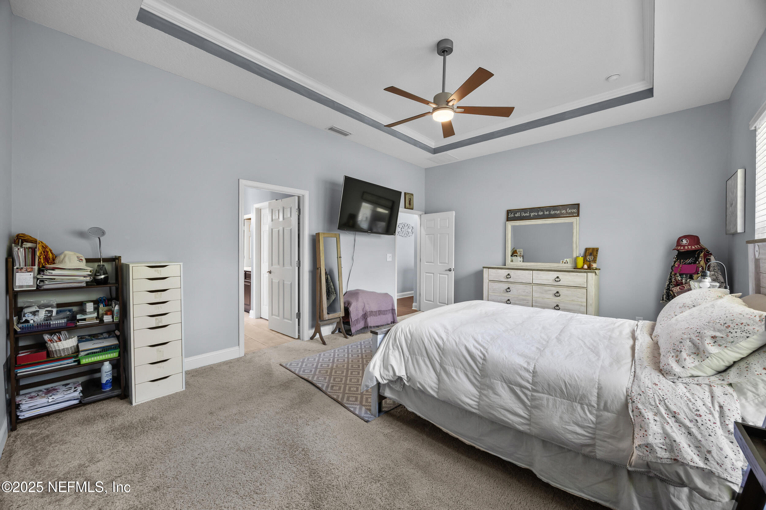 45 Oban Court St. Johns, FL 32259 - Photo 29 of 53 a bedroom with a bed and a chandelier