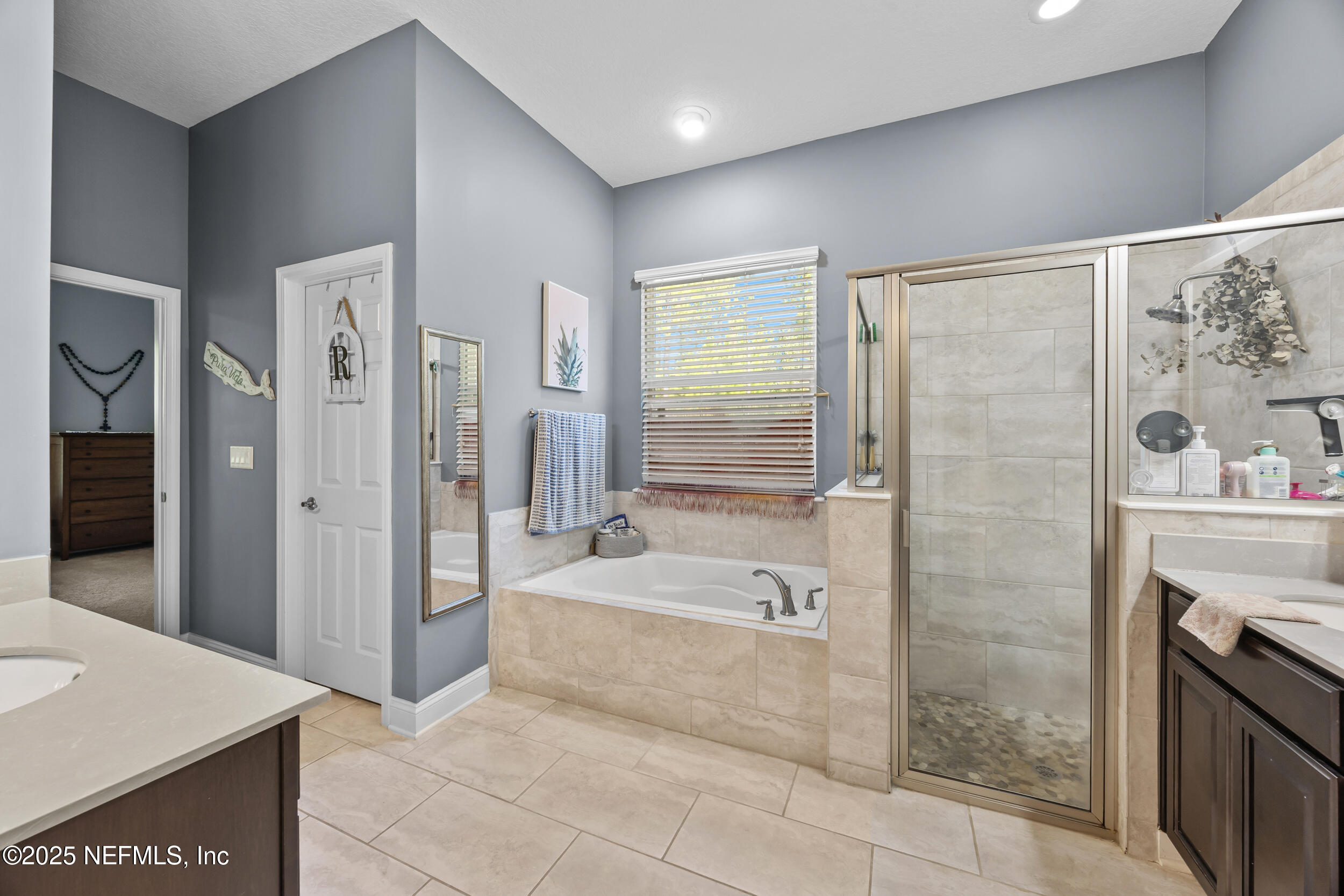 45 Oban Court St. Johns, FL 32259 - Photo 31 of 53 a spacious bathroom with a tub shower sink and mirror