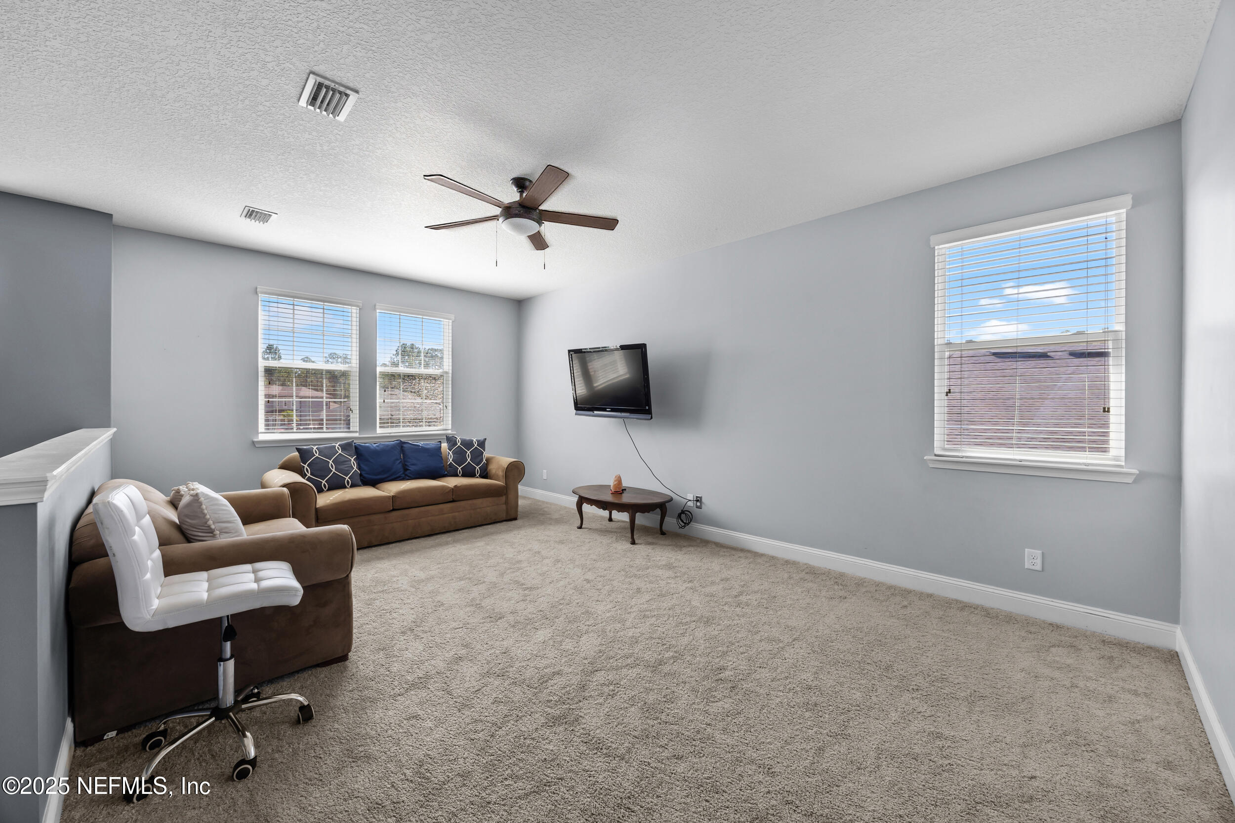 45 Oban Court St. Johns, FL 32259 - Photo 32 of 53 a living room with furniture and a flat screen tv