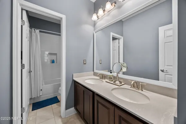 a spacious bedroom with a bed and a chandelier