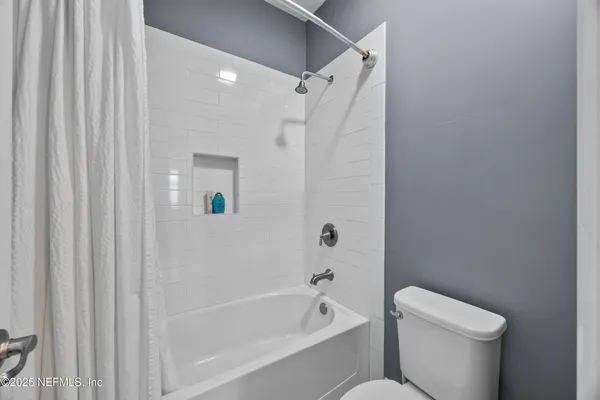 a view of a livingroom with a ceiling fan and window
