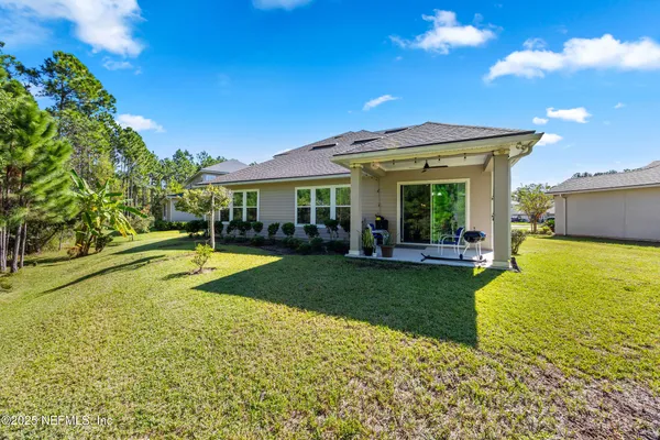 a view of a chair and table in the garden