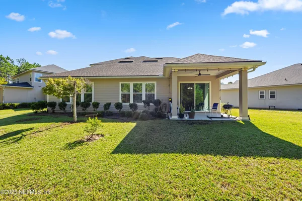 a front view of a house with yard and green space