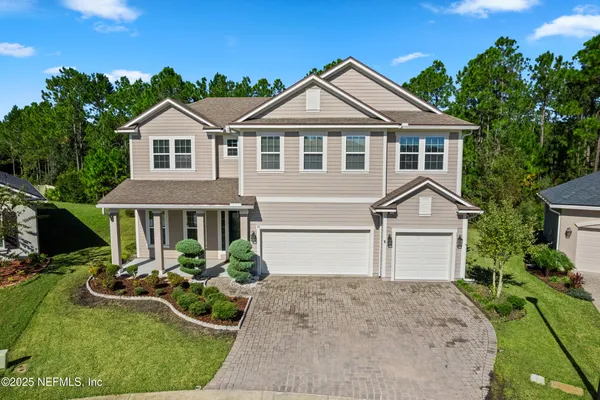 an aerial view of a house with a yard swimming pool a patio and yard