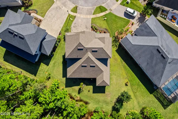 a aerial view of a house with swimming pool garden and patio
