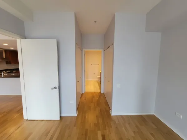 a view of hallway with wooden floor