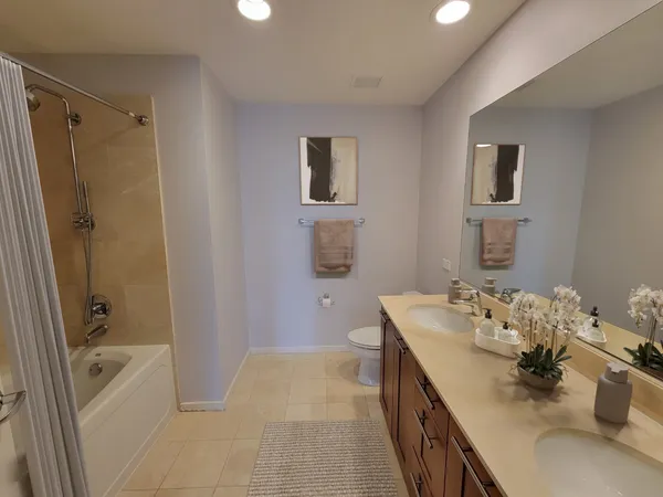 a bathroom with a tub sink and mirror