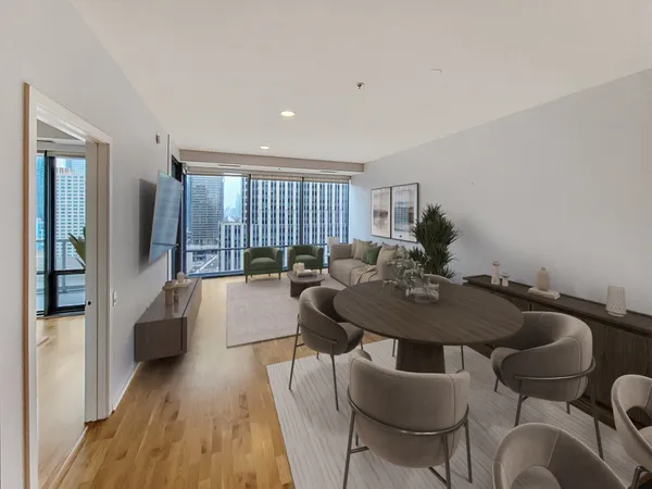 a living room with furniture and a wooden floor