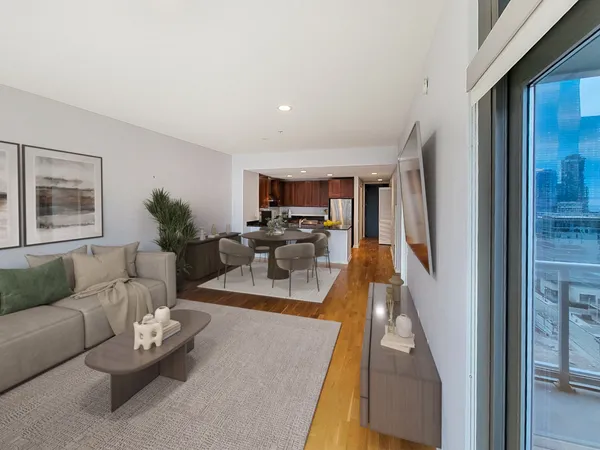 a living room with furniture floor to ceiling window and a flat screen tv