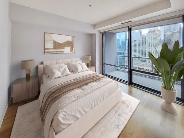 a bedroom with a large bed and a potted plant