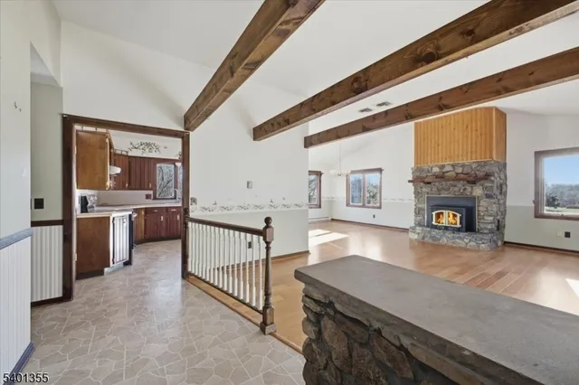 a view of empty room with wooden floor and fireplace