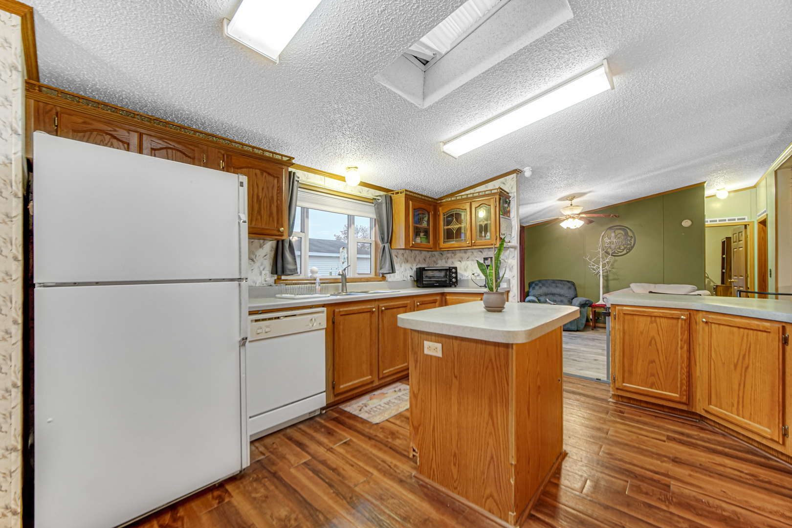 9 Swallow Lane Beecher, IL 60401 - Photo 14 of 24 a kitchen with stainless steel appliances granite countertop a refrigerator a sink dishwasher a stove with wooden cabinets and wooden floor
