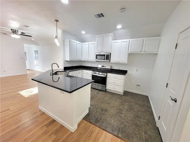a view of kitchen with wooden floor