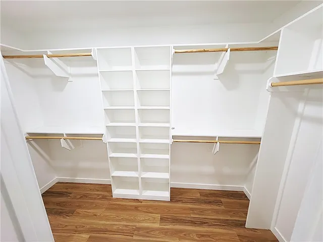 a view of walk in closet with empty racks