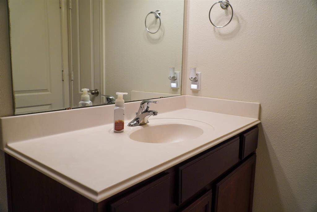 13624 Helix Bridge Way Crowley, TX 76036 - Photo 17 of 25 a bathroom with a sink vanity and a mirror