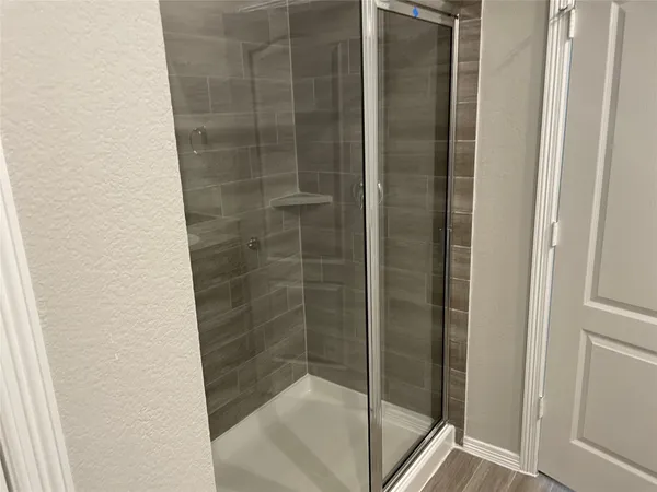 a bathroom with a glass shower door