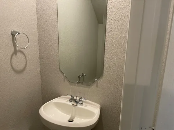 a bathroom with a sink mirror and vanity