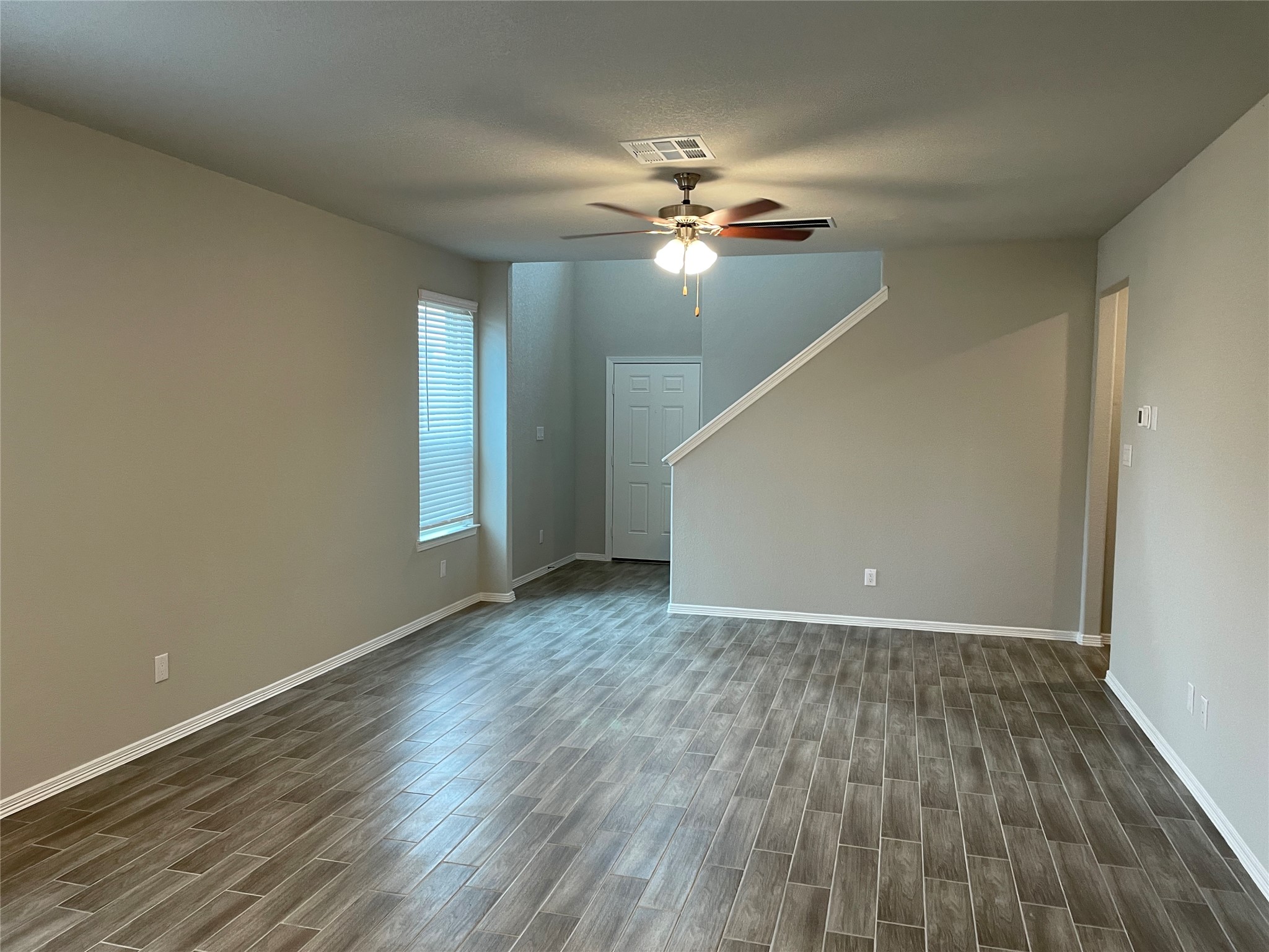 822 Redinger Ridge Drive Houston, TX 77336 - Photo 4 of 21 a view of an empty room with wooden floor and a window