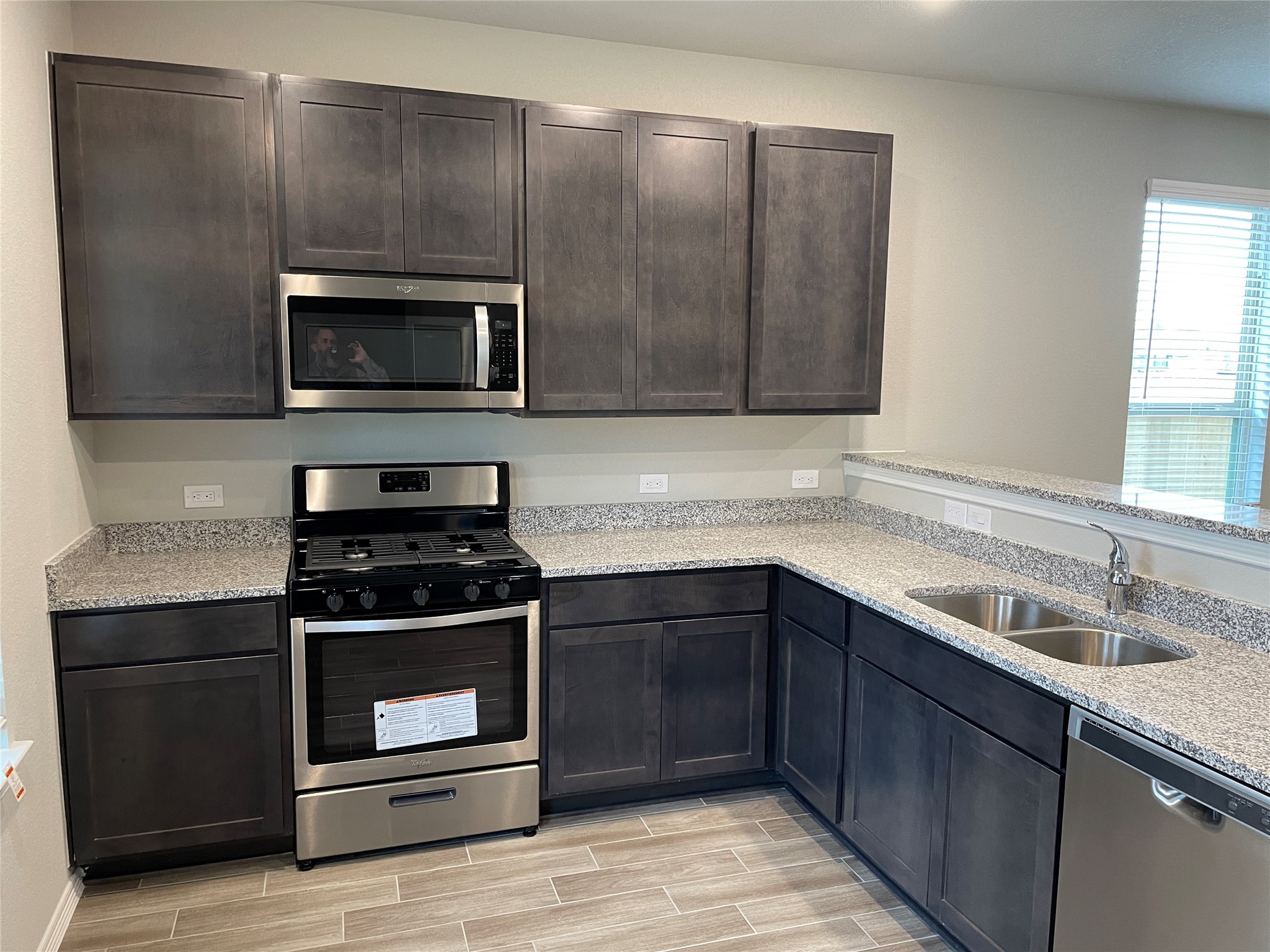 822 Redinger Ridge Drive Houston, TX 77336 - Photo 7 of 21 a kitchen with stainless steel appliances wooden cabinets and a stove top oven