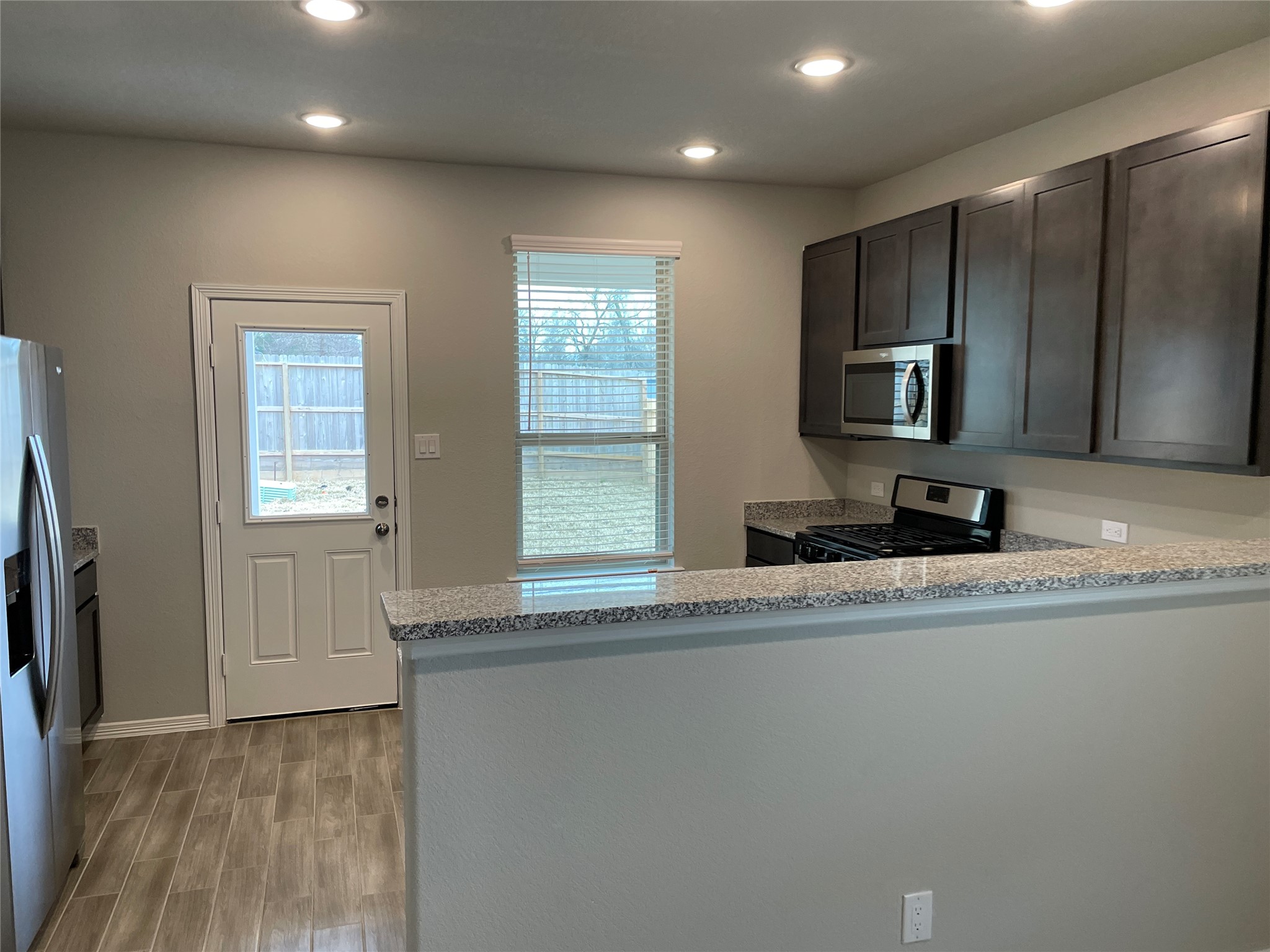 822 Redinger Ridge Drive Houston, TX 77336 - Photo 9 of 21 a view of a kitchen with a sink and a large window