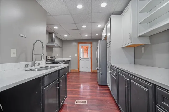 a large bedroom with a bed and a refrigerator