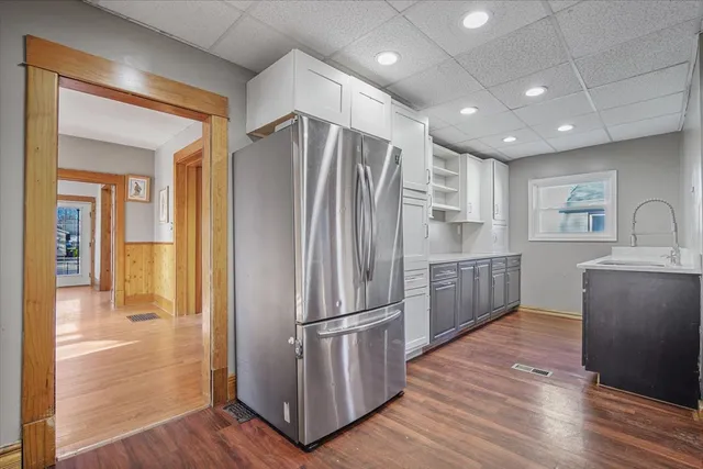 a kitchen with kitchen island a sink stainless steel appliances and cabinets