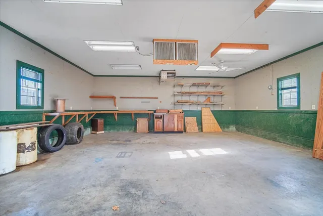 a view of a backyard with wooden fence and large trees