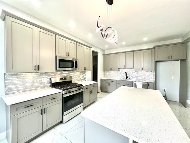 a view of a kitchen with a sink stainless steel appliances and cabinets