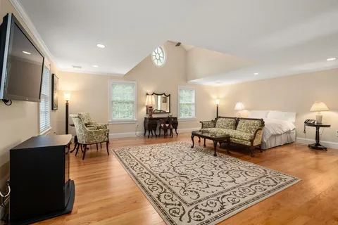 a living room with furniture rug and a flat screen tv
