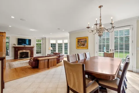a dining room with furniture a fireplace and wooden floor
