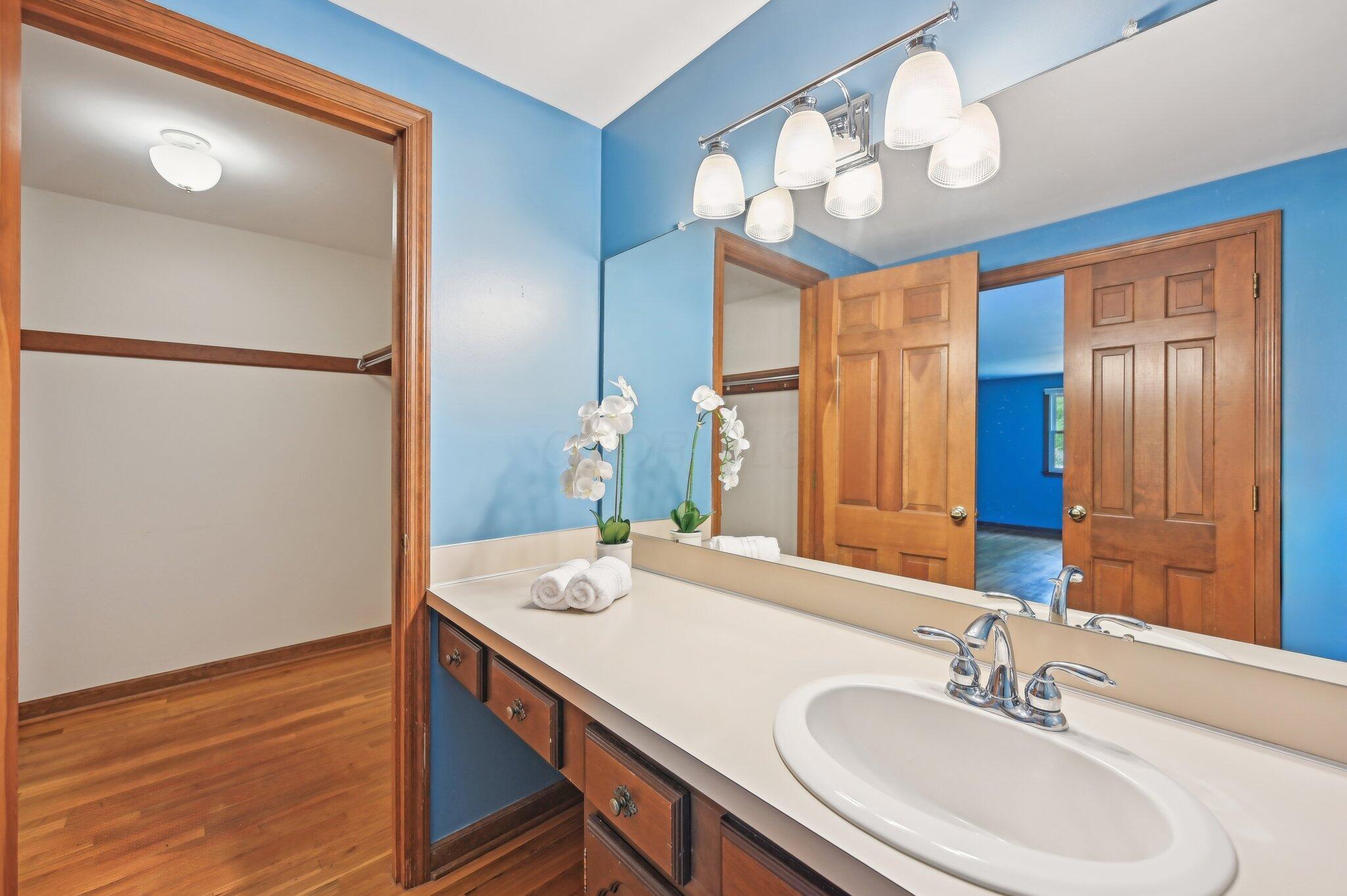 5917 Rocky Rill Road Columbus, OH 43235 - Photo 27 of 47 Dual-entry vanity space in the primary bath with large mirror and access to the walk-in closet.