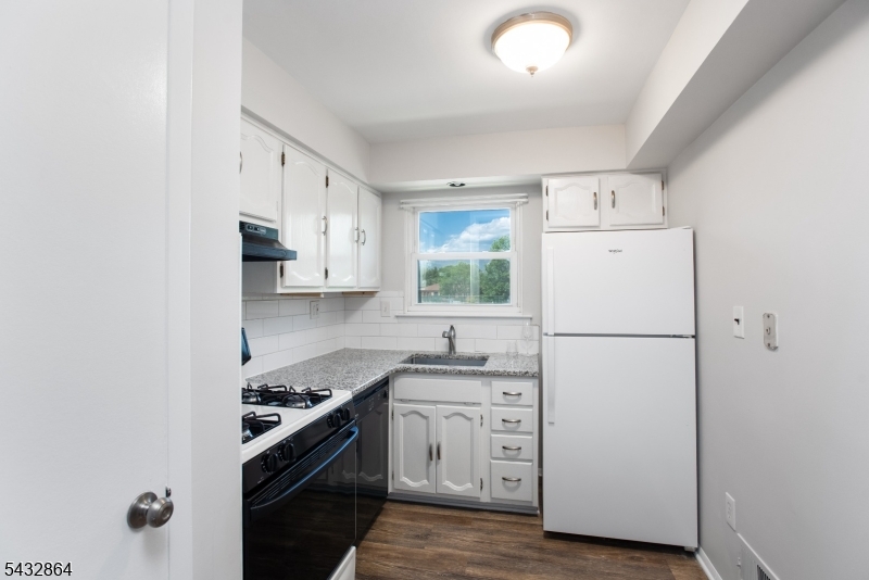 504 Nottingham Way, Unit 504 Flemington, NJ 08822 - Photo 7 of 12 a kitchen with a refrigerator sink stove and cabinets