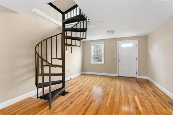 a view of entryway with wooden floor and stairs
