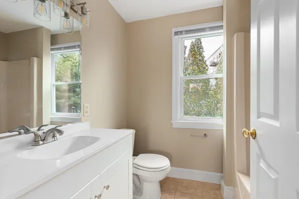 a bathroom with a sink a toilet and a mirror