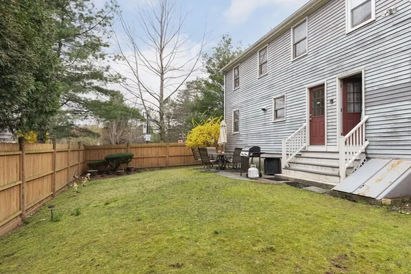 a view of a house with a yard and sitting area
